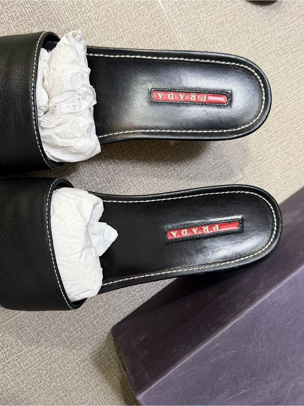 Prada Black Leather Slide Mules with Red Logo Inset